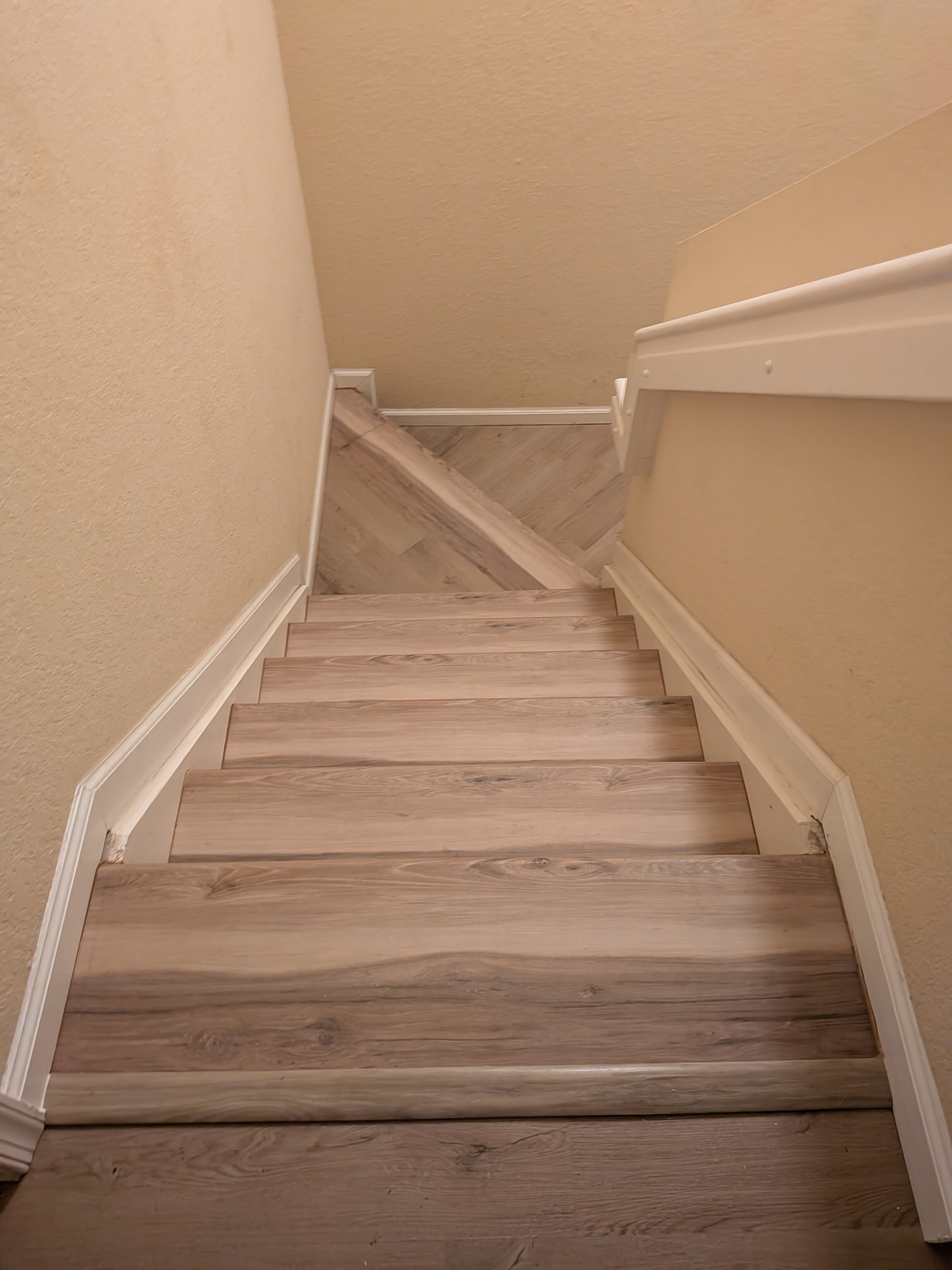 Wooden staircase with white railings