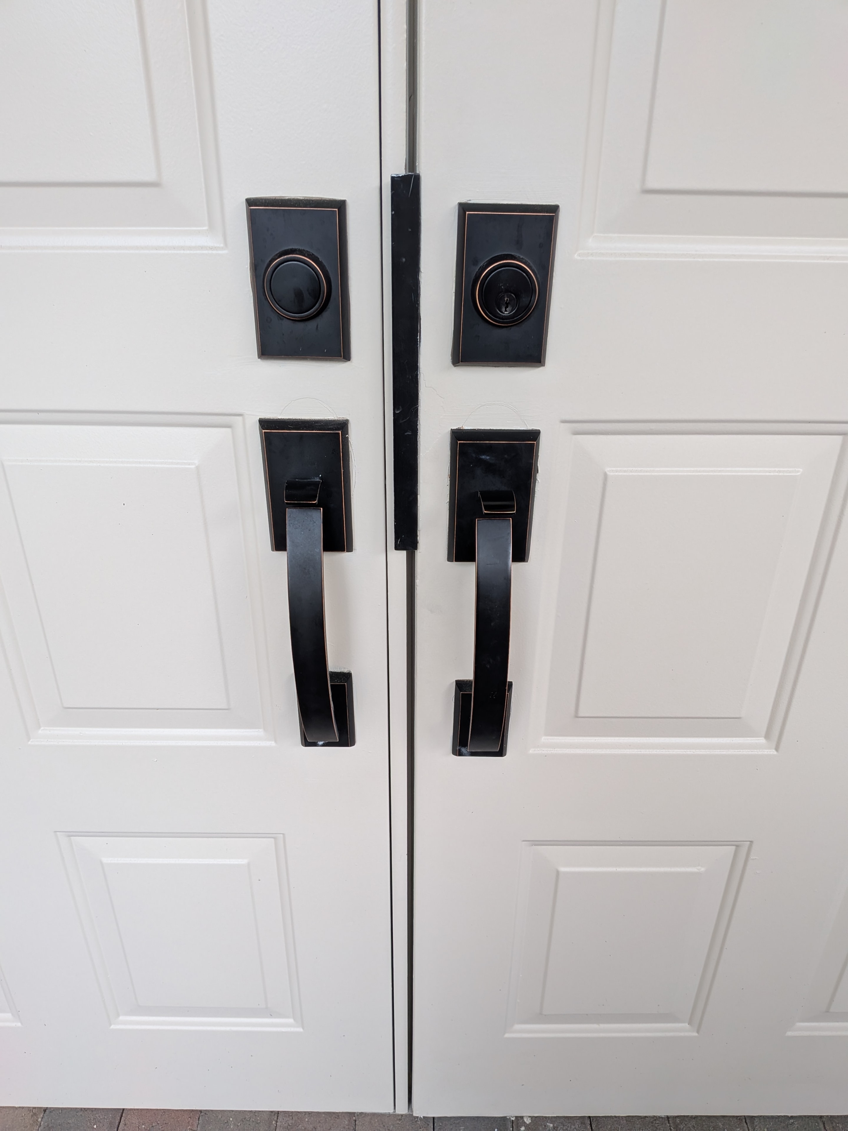 Black hardware on white double doors
