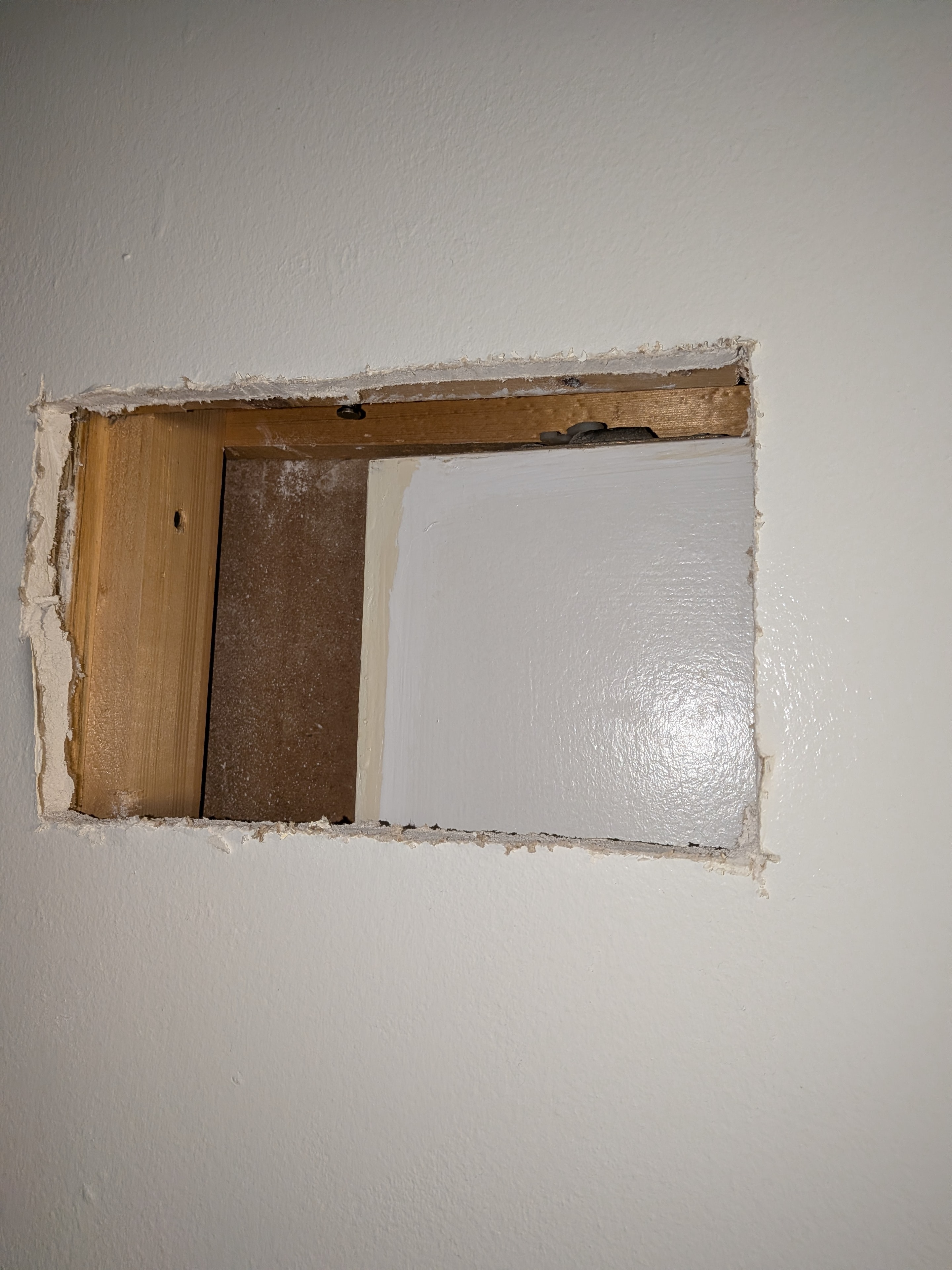 Unfinished wall opening with wooden frame