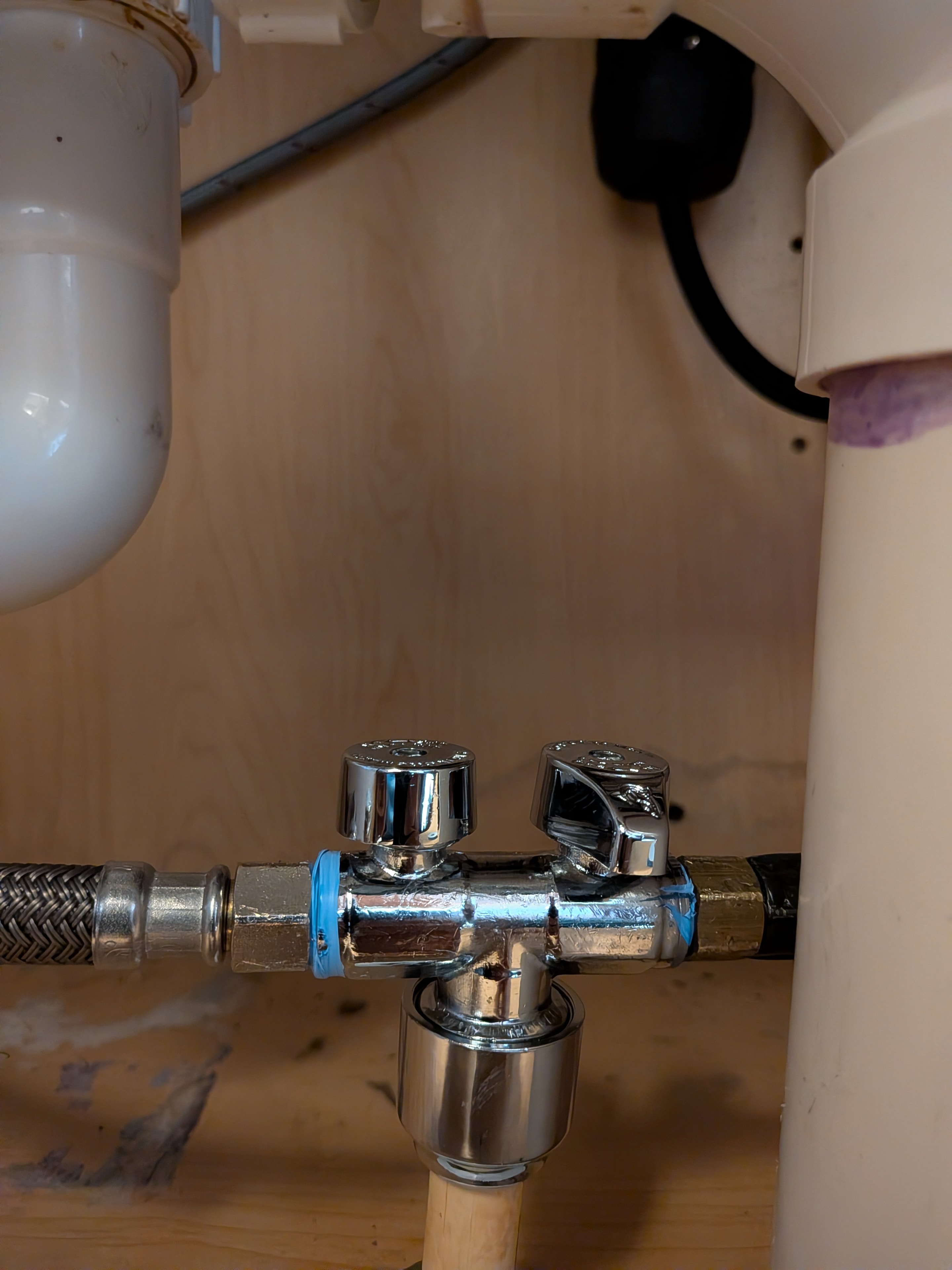 Chrome water shut-off valve under sink