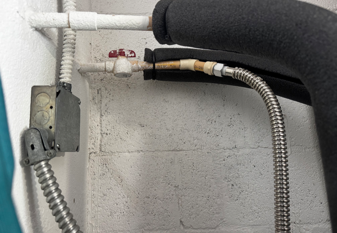 Plumber installing water supply connection