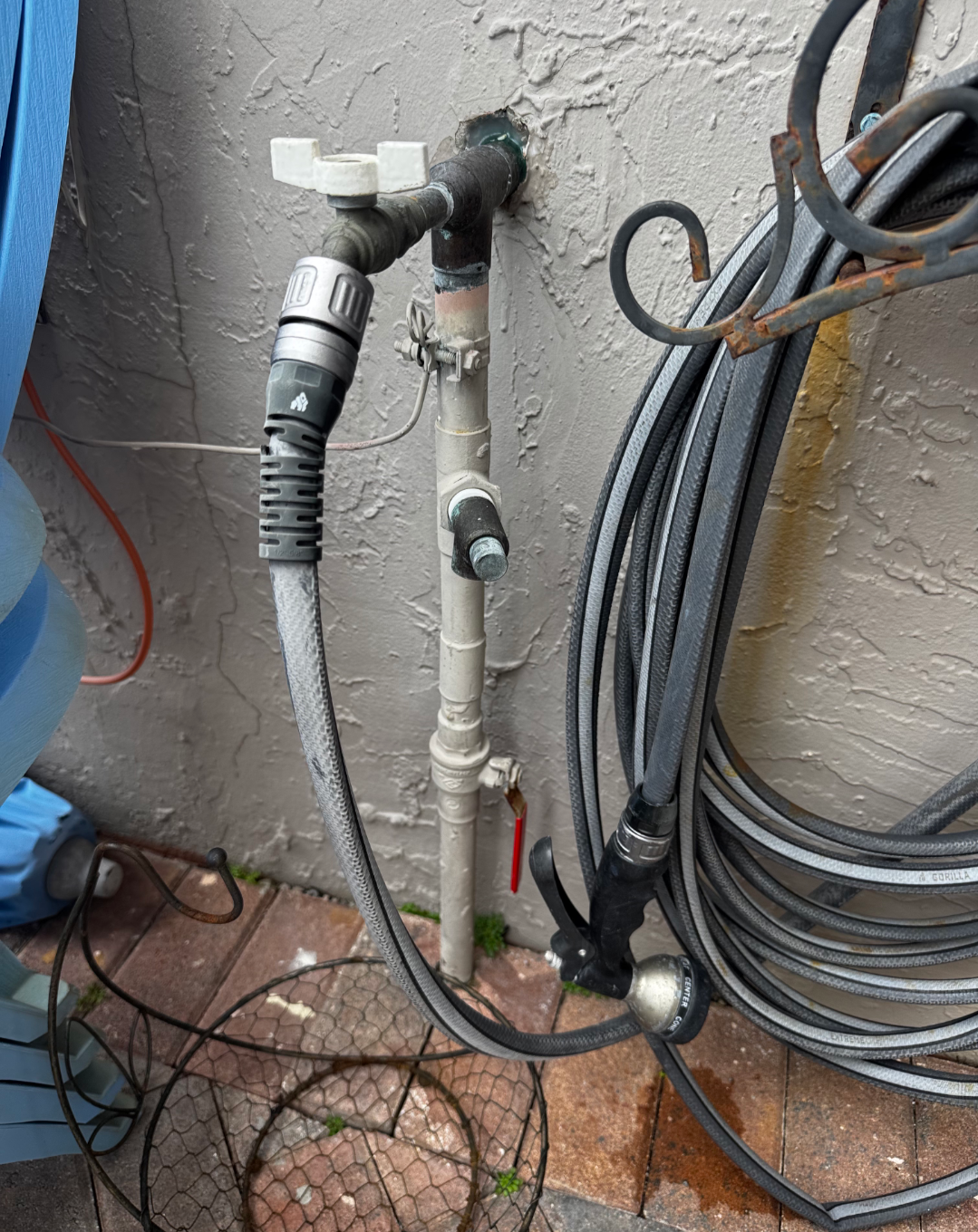 Outdoor faucet with coiled hoses attached