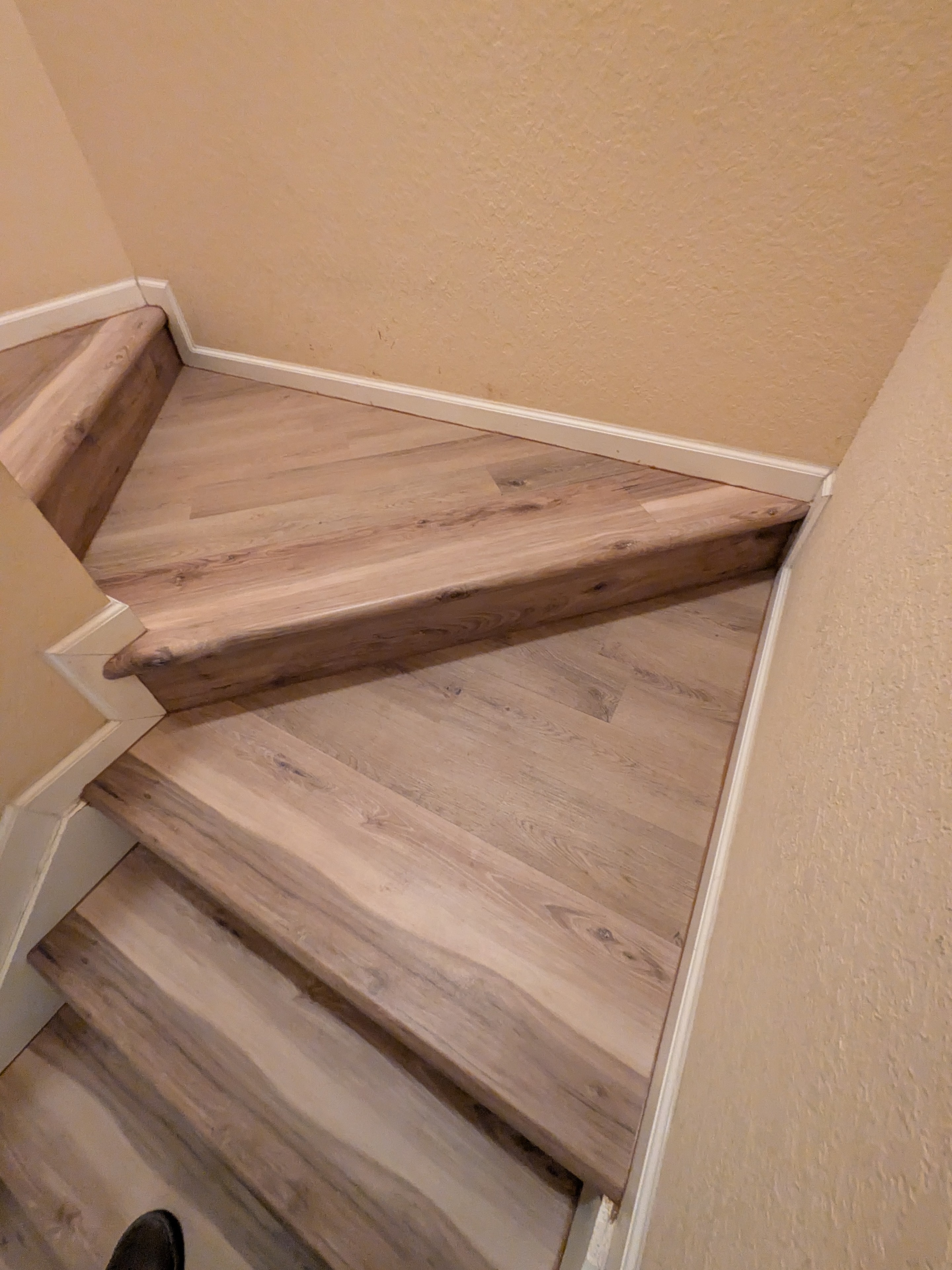 Wooden staircase with white trim interior