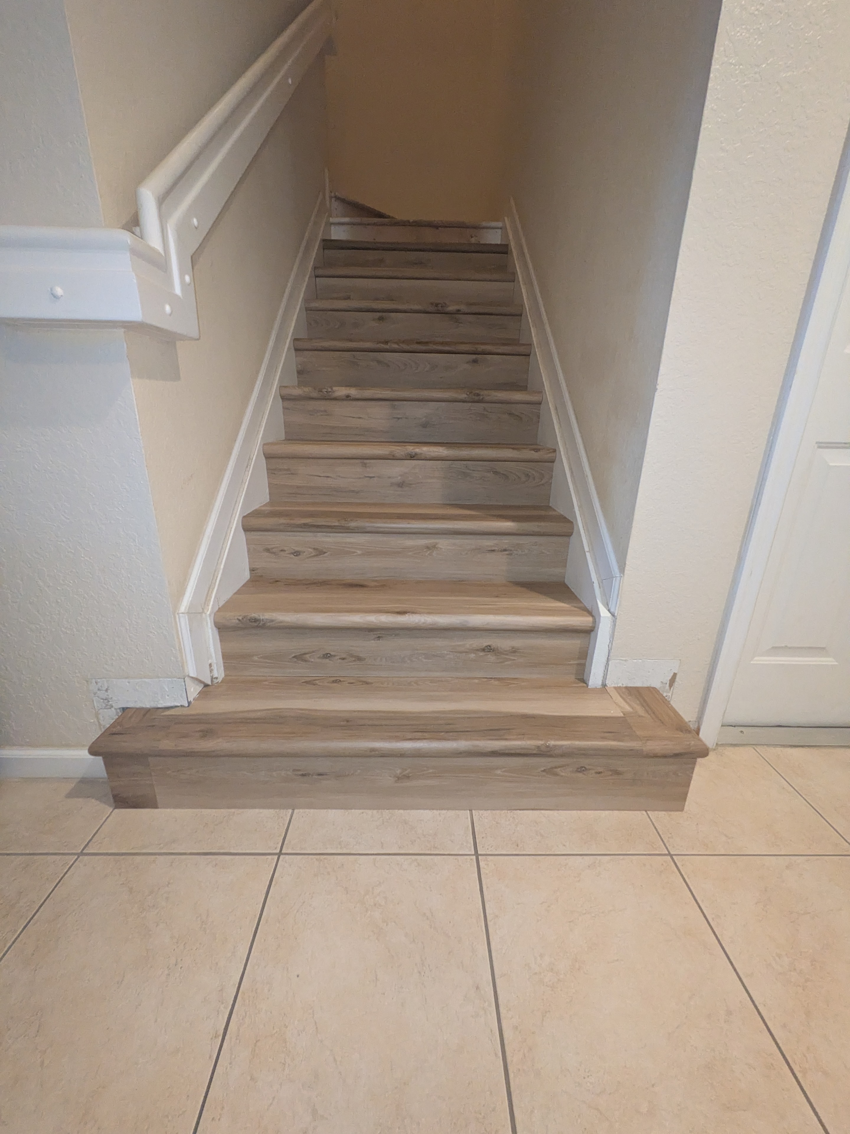 Wooden staircase with white railings upward view